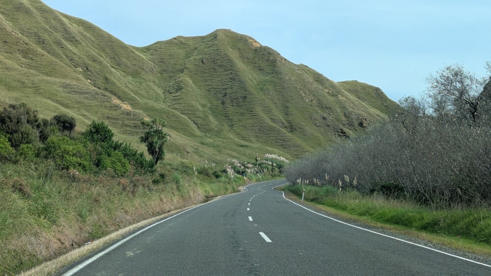 Route de campagne vallonnée dans le nord de la Nouvelle-Zélande. Paysage calme pris en autostop
