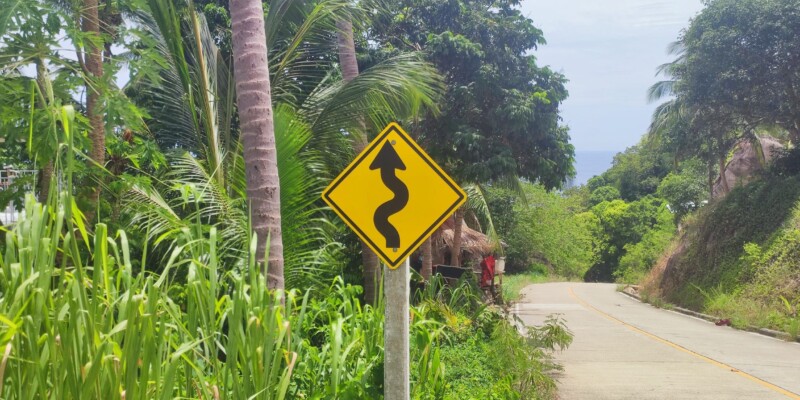 Flèche noire indiquant la direction de Koh Tao sur un fond jaune
