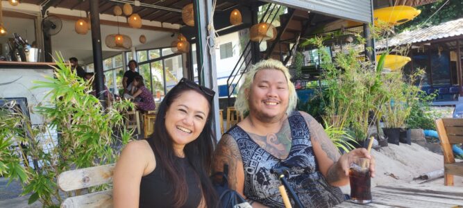 Une femme et un homme thaïlandais souriant joyeusement à Koh Tao, entourés de paysages tropicaux