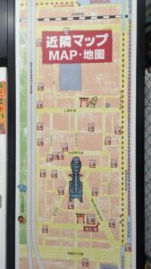 Le Japon, un pays jeu vidéo grandeur nature Carte stylisée d'Osaka avec la tour Tsutenkaku comme point central, illustrée dans un style de jeu vidéo coloré