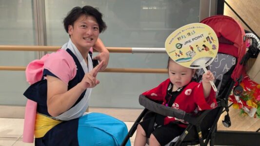 Photo d'un père déguisé pour le festival et de son enfant avec un paravent décoratif d'Aomori