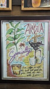 Affiche mettant en avant les grains de café Arabica dans un café à Bangkok