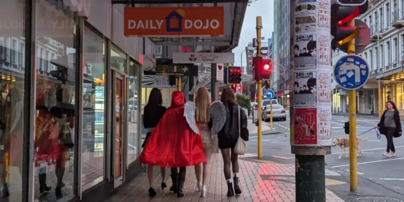 Quatre personnes de dos, déguisées en anges, célébrant Halloween à Wellington